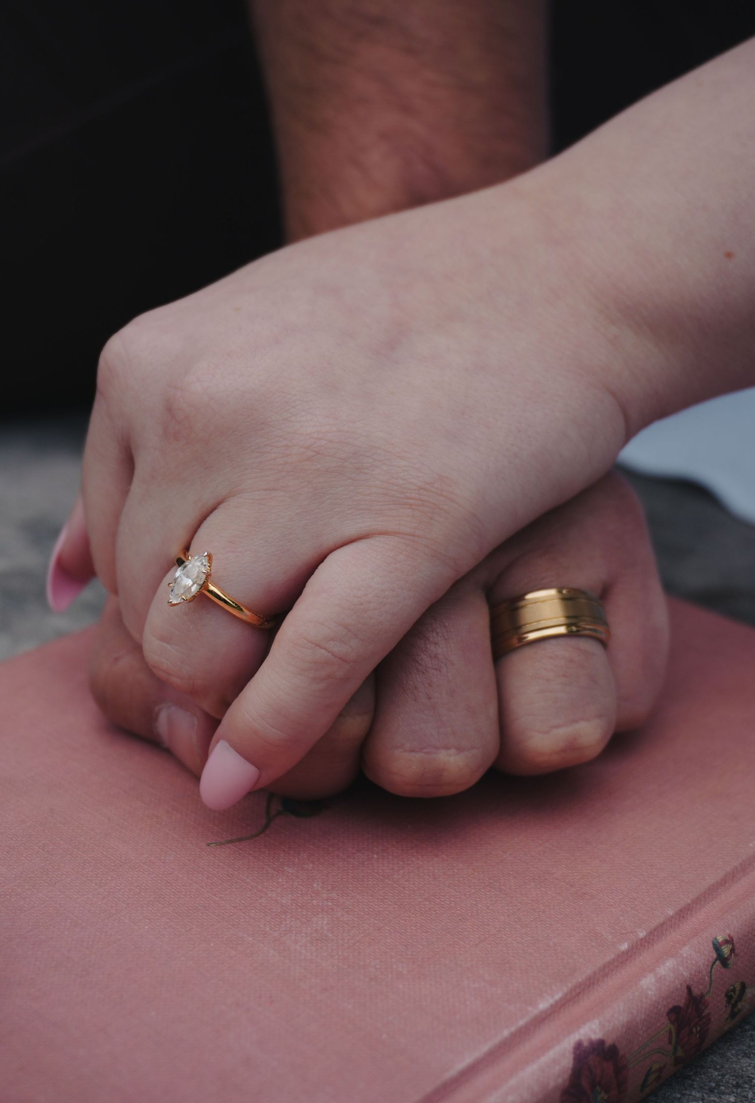 Photo of Gracie & Rayden's hands with rings.