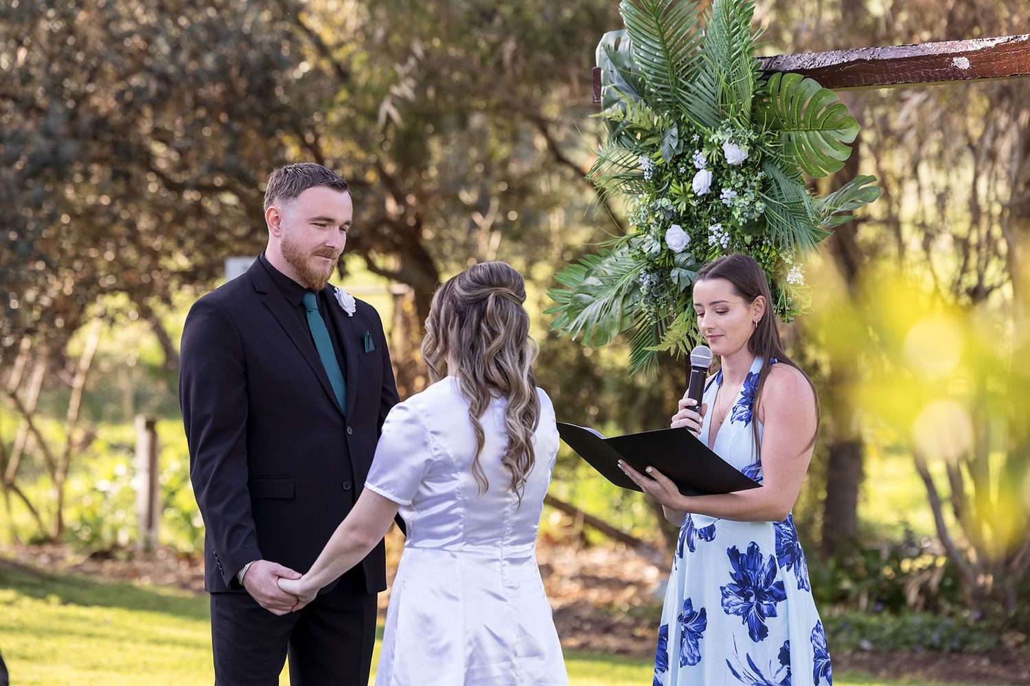 A Bride and Groom share a moment together during their vows in their outdoor wedding ceremony at Kimo Estate Gundagai.