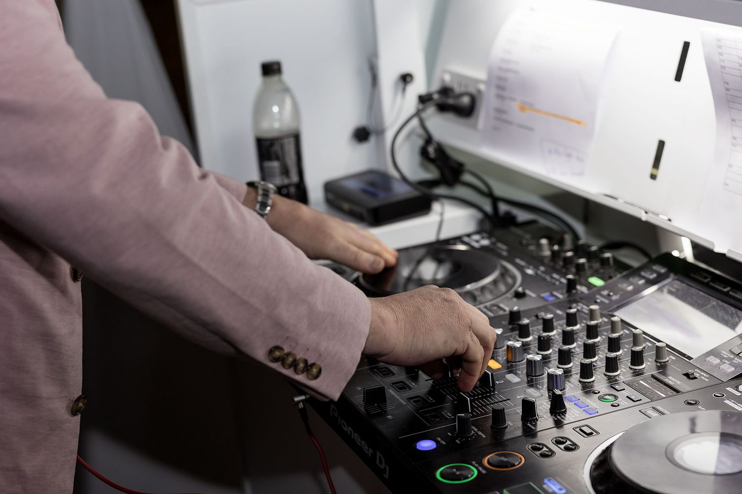 The DJ playing music on the DJ booth during a reception at the Grain Shed Reception venue at Kimo Estate Gundagai