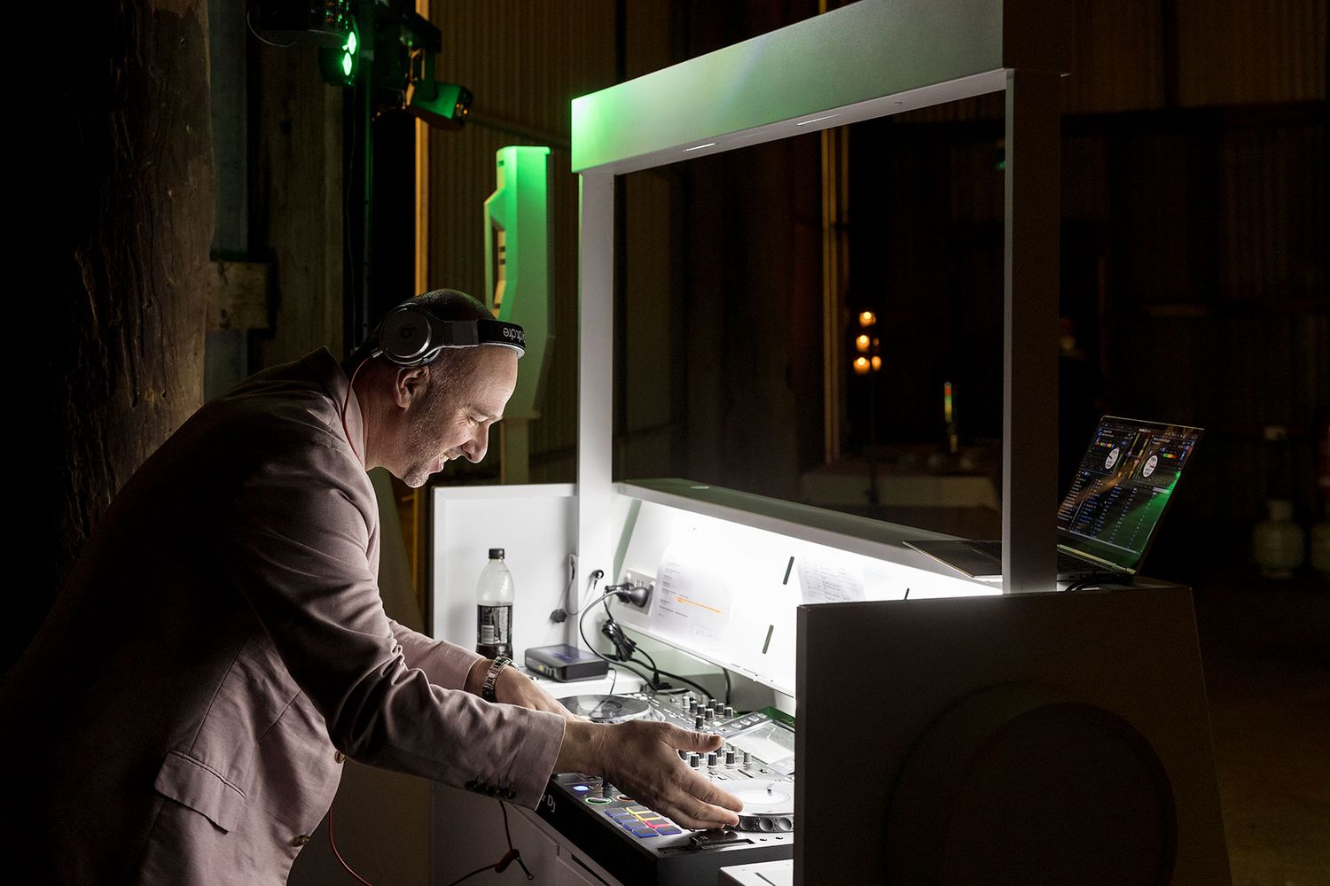The DJ playing music on the DJ booth during a reception at the Grain Shed Reception venue at Kimo Estate Gundagai
