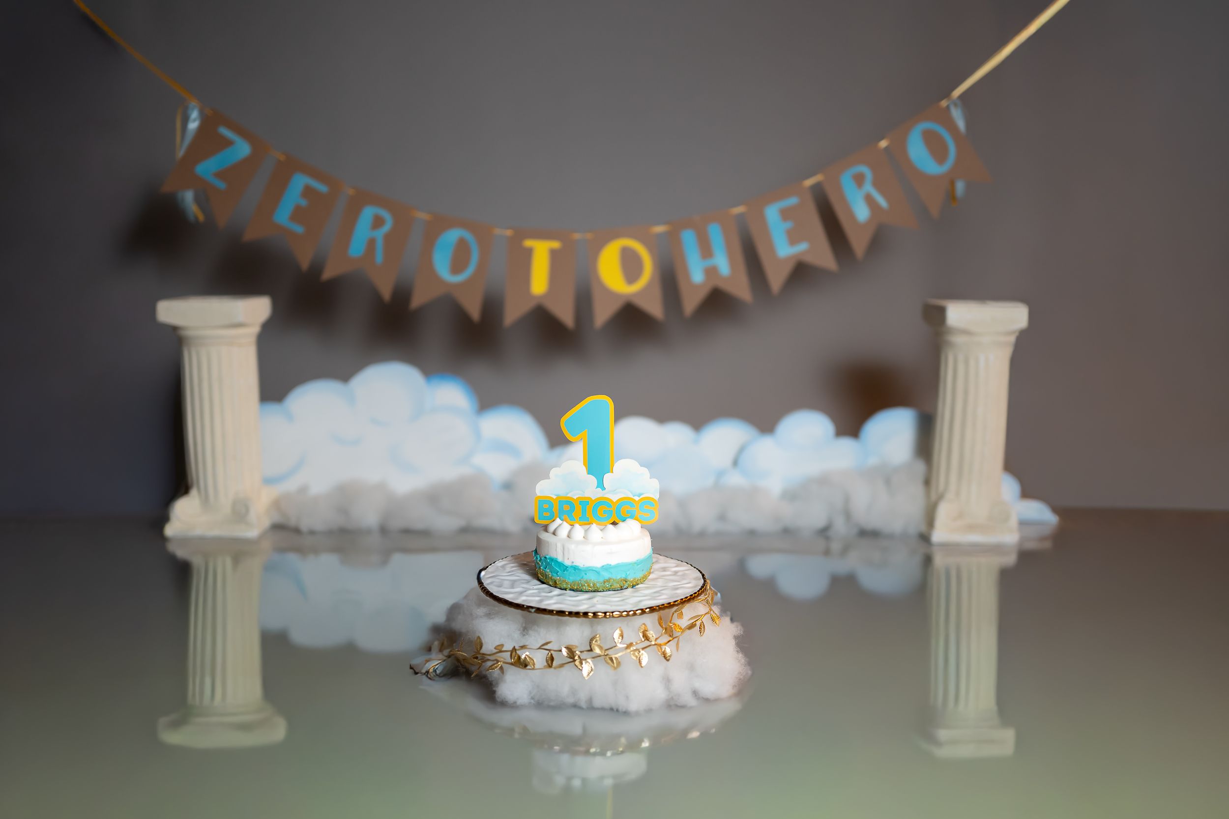 A sequence of photos showing a cake decoration setup with pillars, cotton clouds, and a glowing teal cake topper on display.