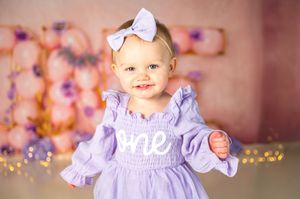 Image collection shows a purple dress against a sparkly bokeh background with soft pink and lavender tones.