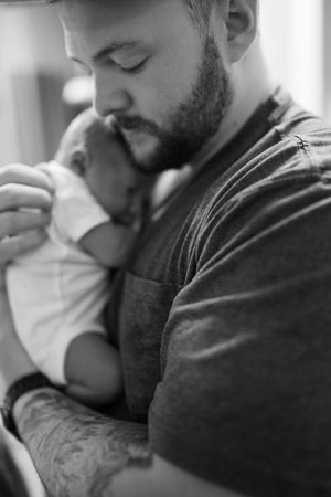 Series of intimate black and white photographs capturing nurturing moments in a hospital setting.