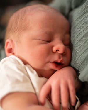 A sleeping newborn baby swaddled in gray fabric shown in six close-up profile shots from different angles.