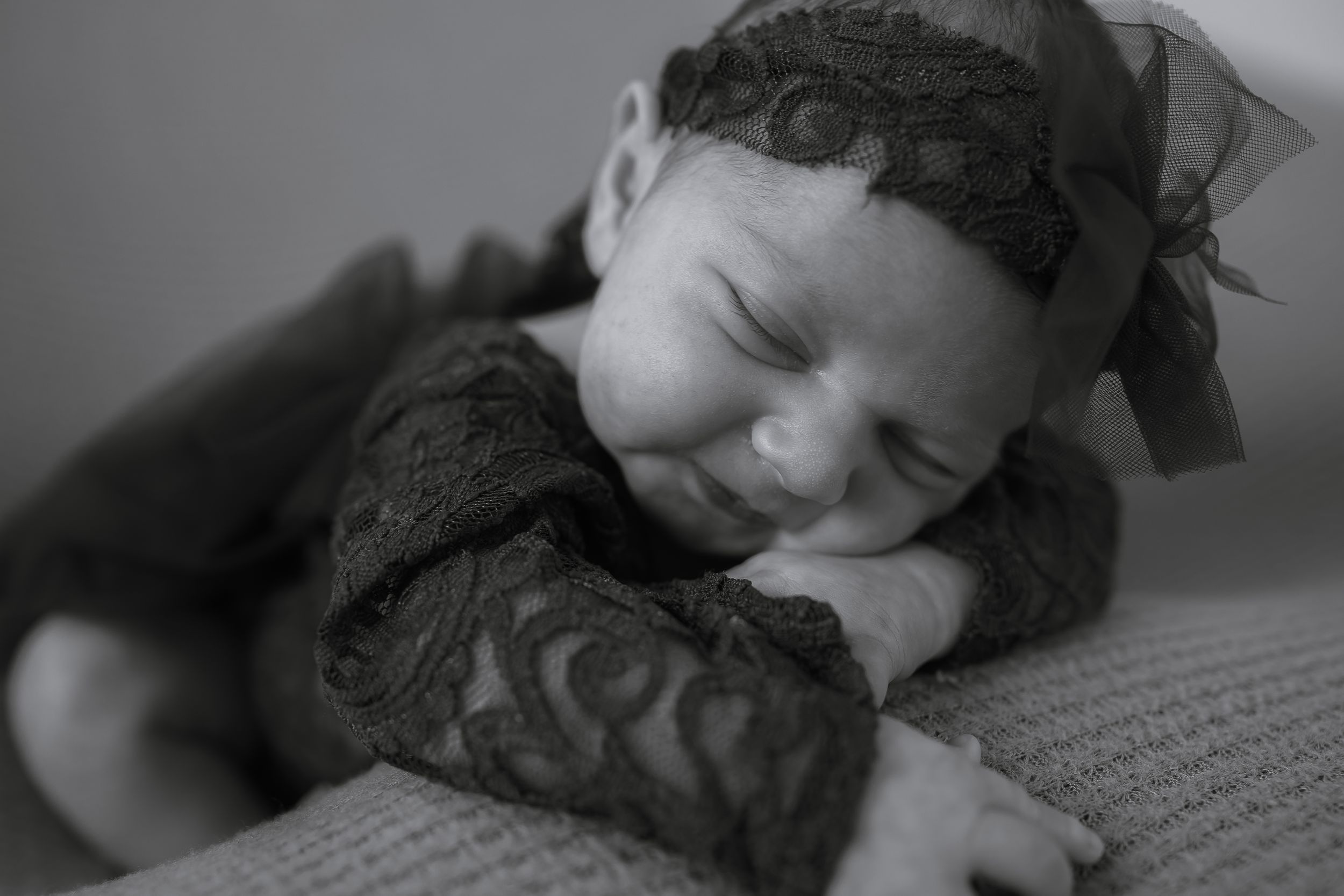 Multiple black and white images showing someone asleep while using a book as a pillow on a desk.