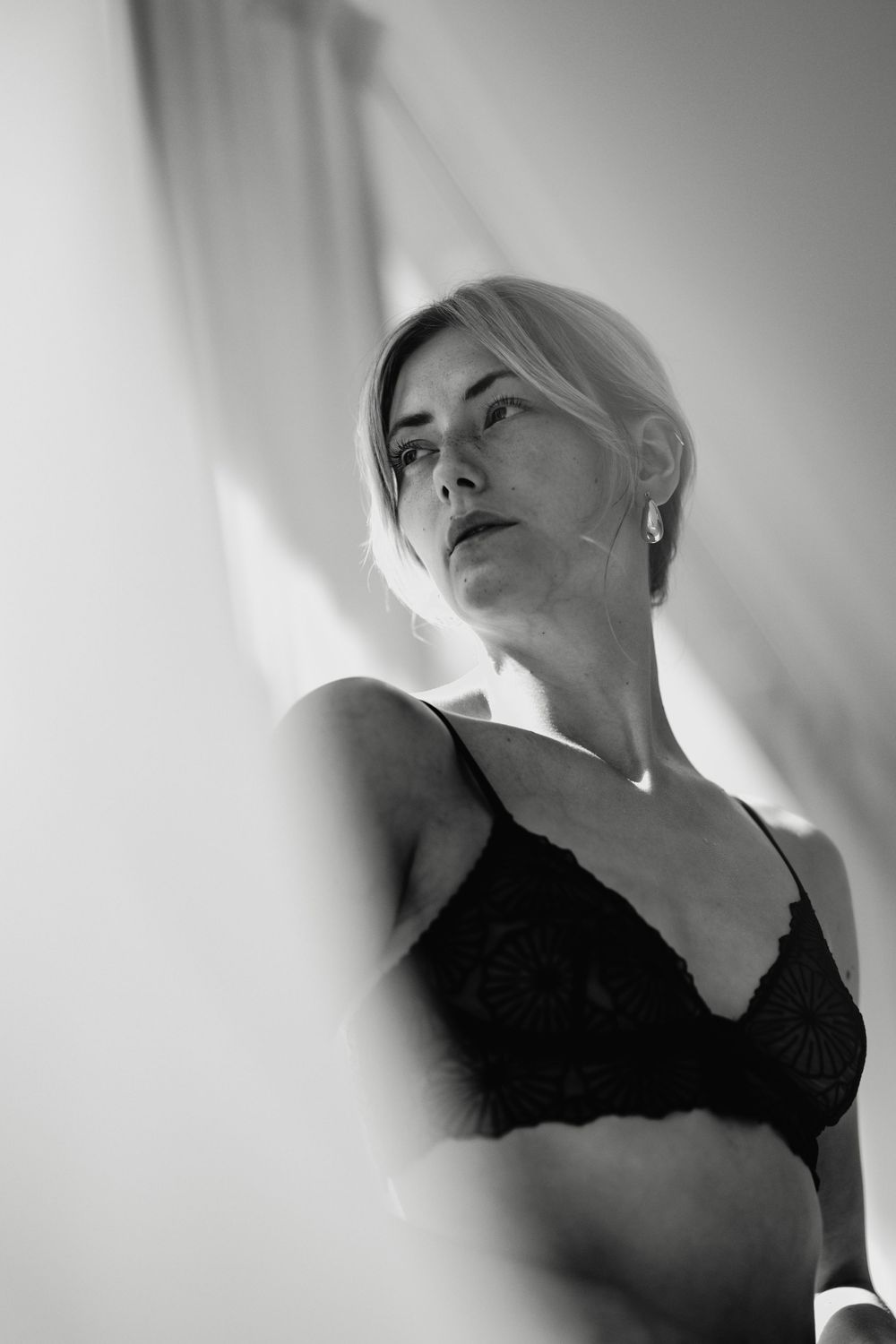 Dramatic black and white boudoir portraits with moody lighting.