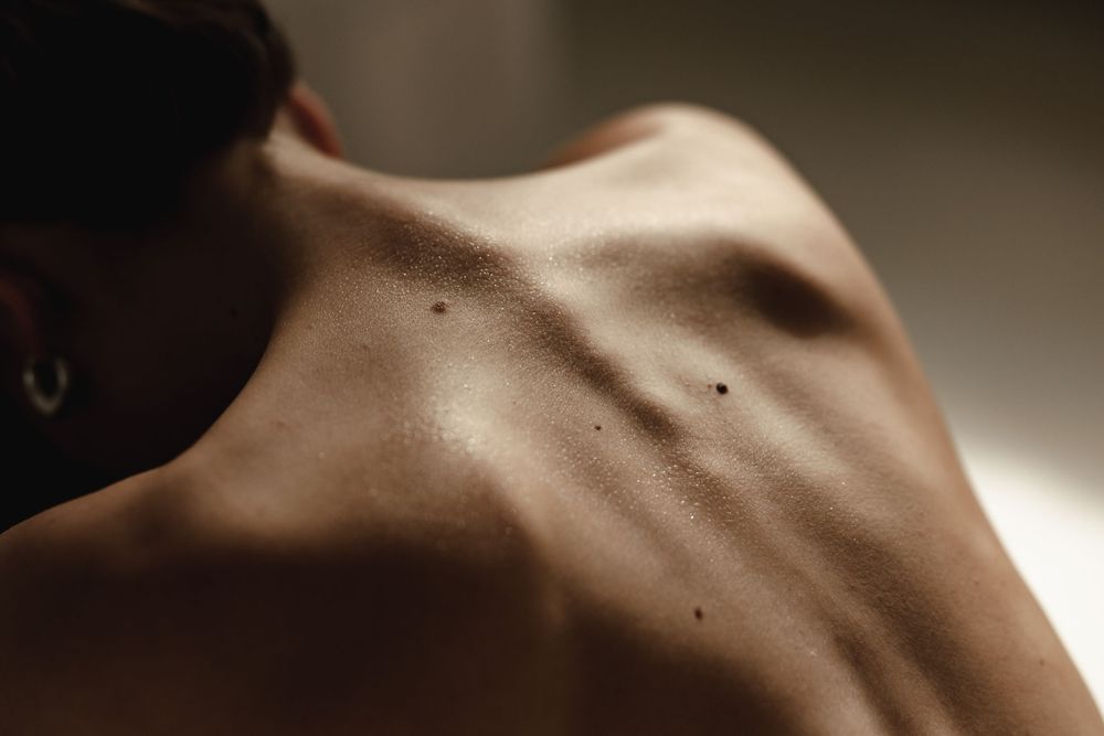 Close-up artistic photograph of skin texture in dramatic lighting.