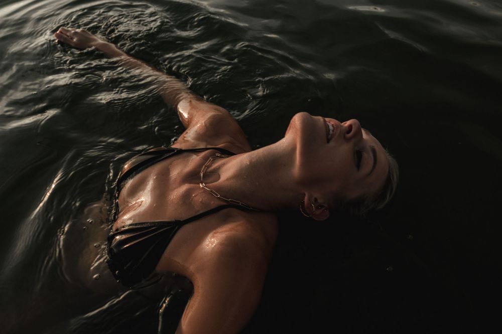 Artistic water portrait with dark moody tones and gentle ripples creating atmosphere.