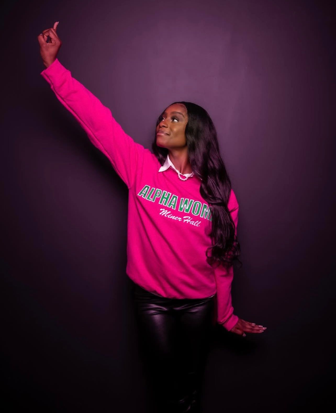 Series of dynamic poses in bright pink sweatshirt against dark purple background.