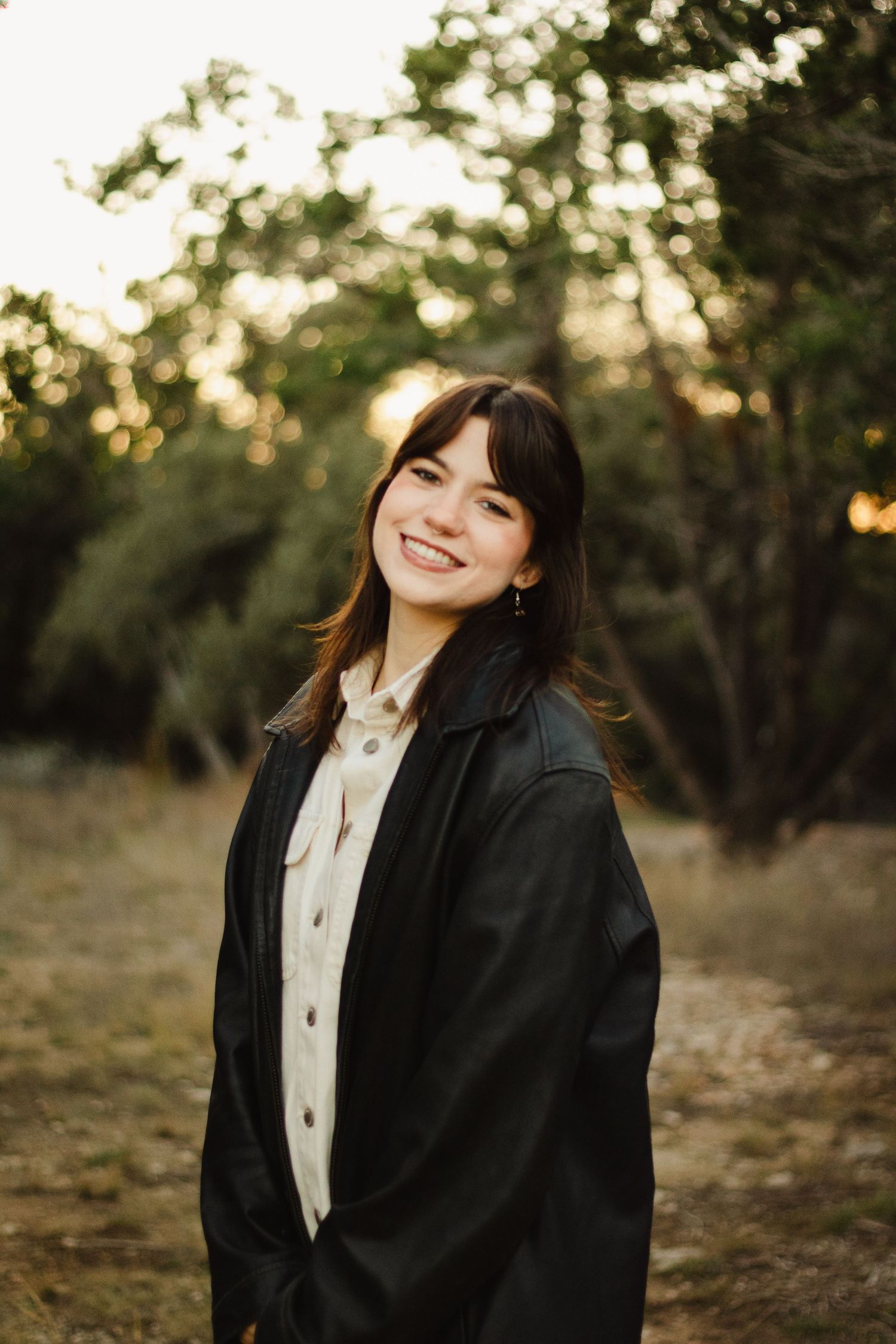 Professional outdoor portrait of someone wearing a black blazer and white shirt in golden hour lighting.
