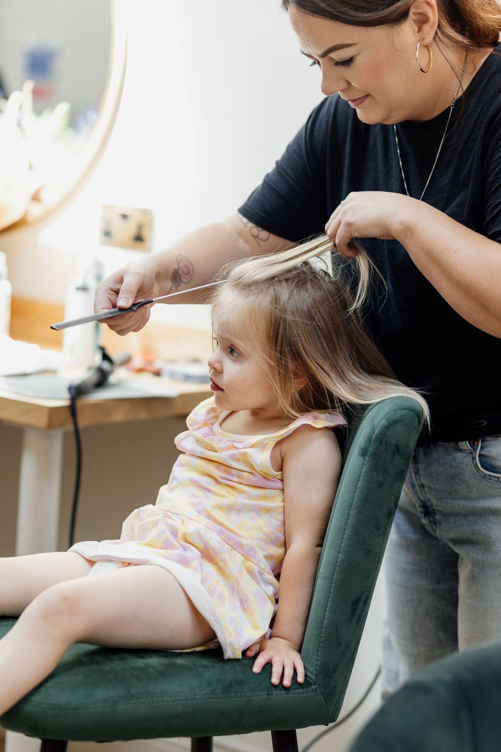 A child receiving medical care or checkup while sitting in a green armchair.