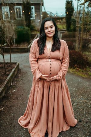 A flowy peach-colored dress with puff sleeves and button details is showcased in a series of outdoor photos.