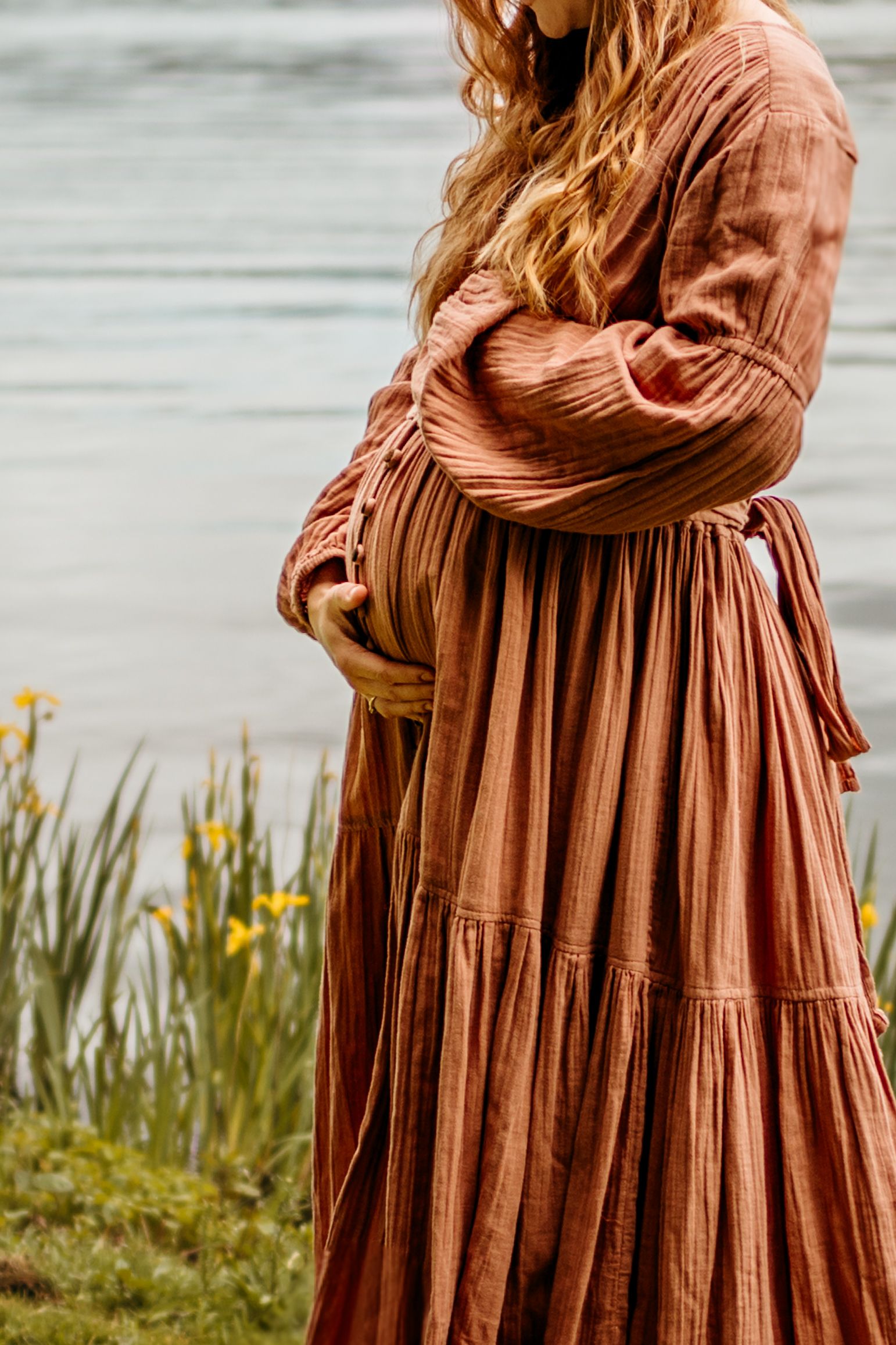 Close-up details of a rust-colored prairie dress with gathered fabric shown from different angles near wildflowers.