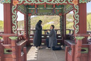 A traditional Asian pavilion with ornate decorative details and red pillars.