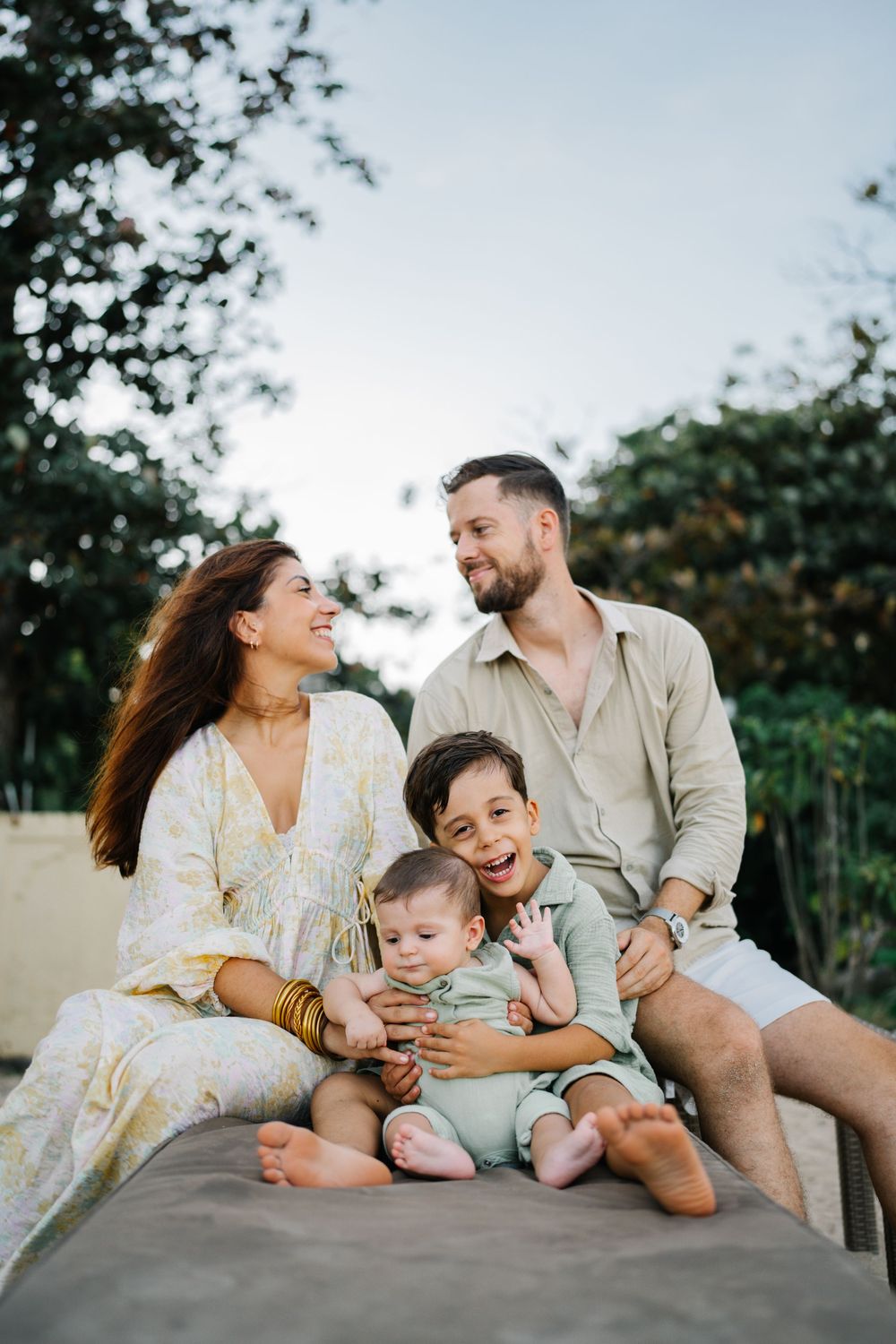 A joyful family shares candid moments together while relaxing outdoors.