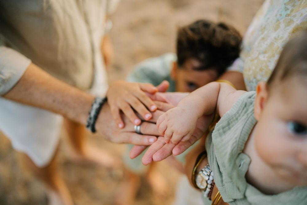 Close-up shot of family hands joined together in unity.