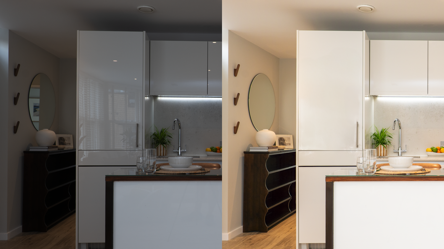 Modern white kitchen interior with contemporary pendant lights and black accents showcases clean lines and minimal design.
