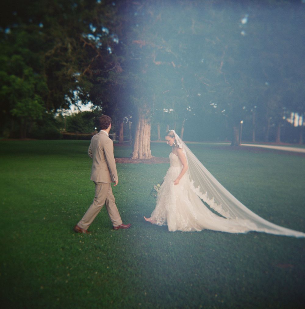 A dreamy sequence showing the progression of a couple walking across a misty garden during an outdoor wedding ceremony.