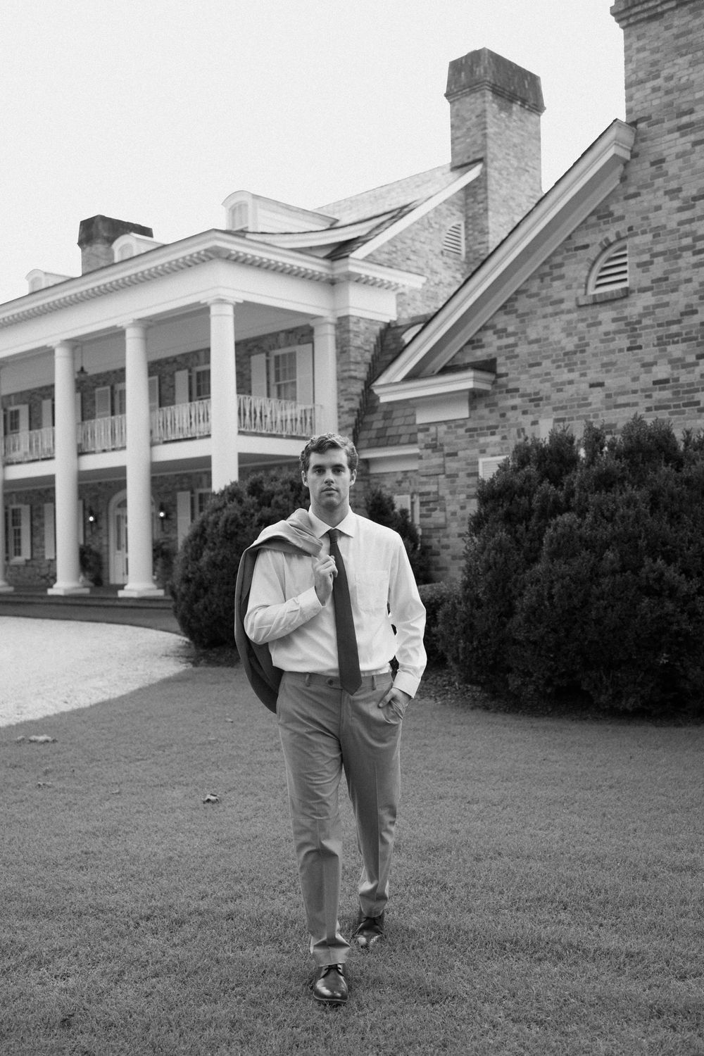 A sequence of black and white photos showing someone walking on a lawn in front of a large columned mansion building.