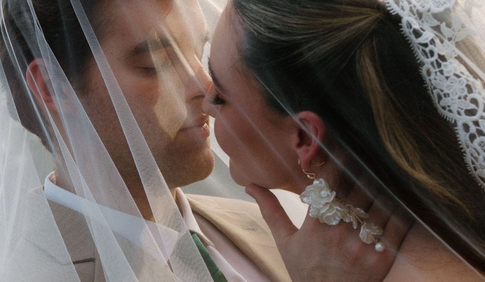 Three couples in wedding attire share romantic kisses in a collage of wedding portraits.