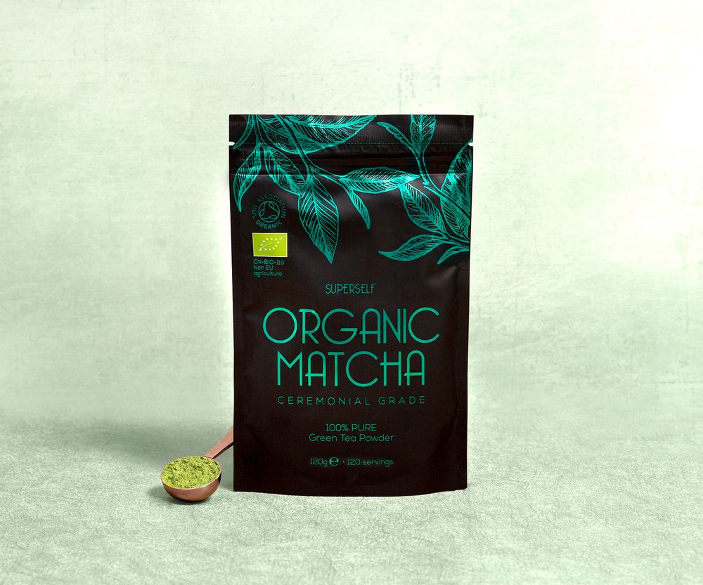 Package of organic matcha powder with decorative green leaf pattern on dark background.