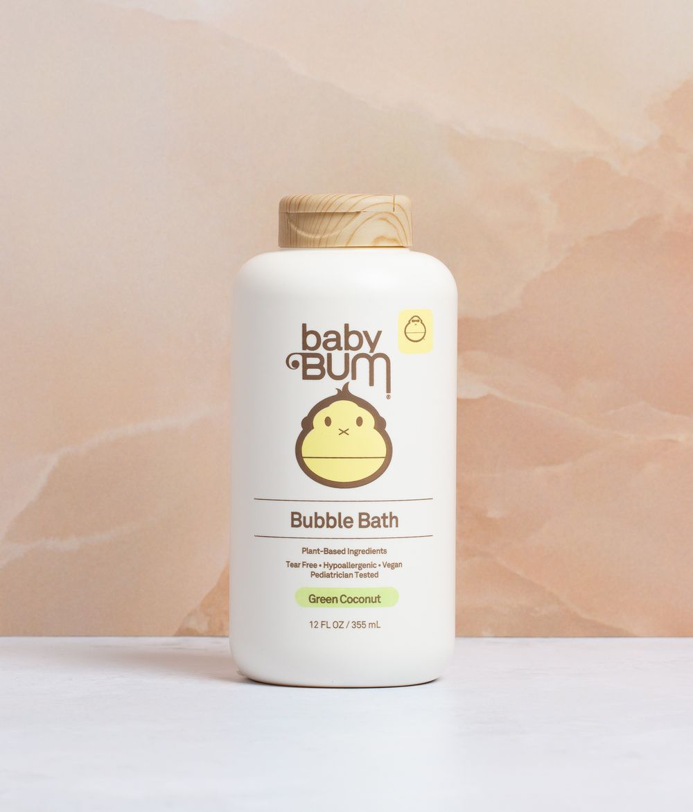 Natural baby skincare products with minimalist packaging against neutral beige background.