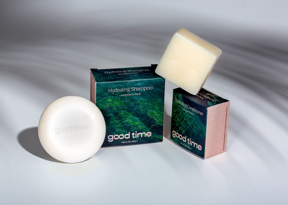Natural soap bars and packaging with forest-inspired design on gray background.