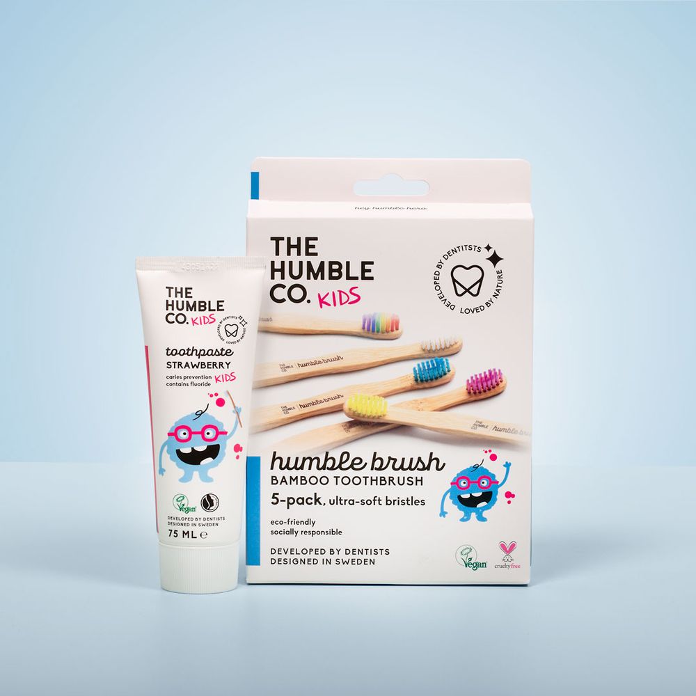 Set of colorful bamboo toothbrushes and dental care products from The Humble Co.