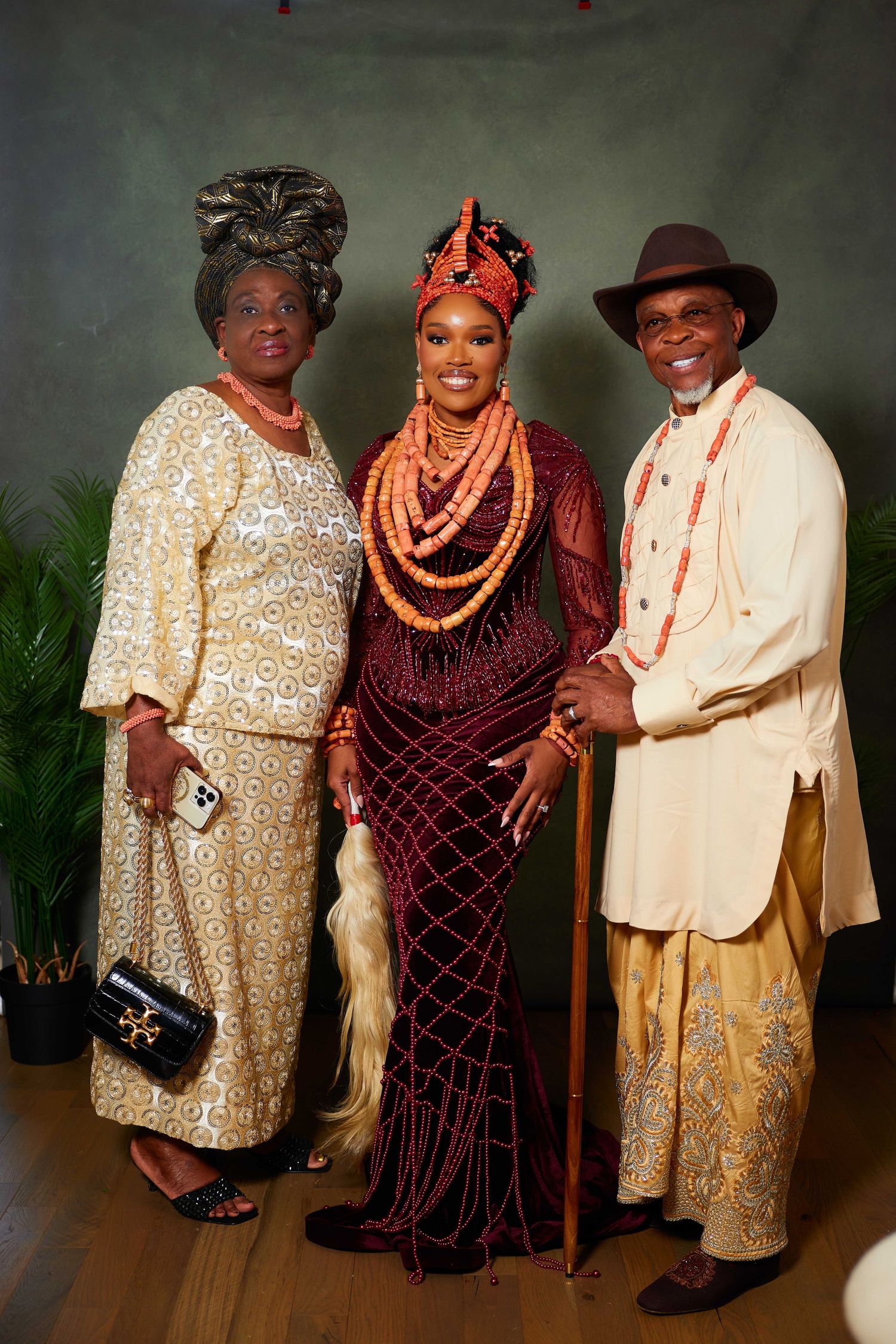 Group photo showing traditional Nigerian cultural attire with ornate beaded jewelry and formal dress clothing.