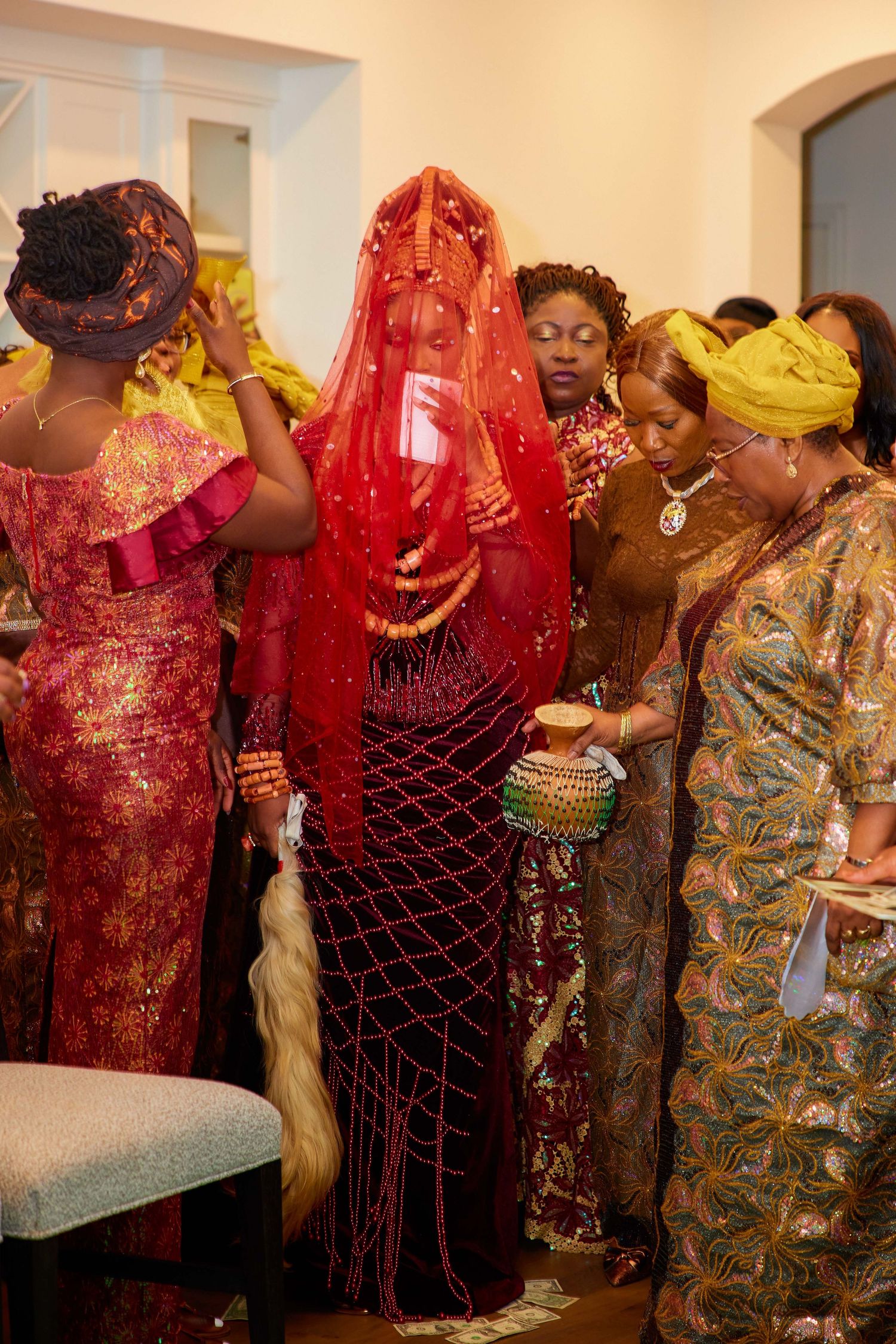 Group of people in colorful traditional African attire celebrating at a cultural event or ceremony.