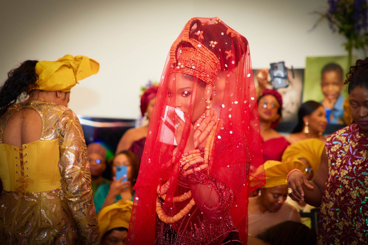 Wedding guests in colorful traditional Indian attire dance and celebrate during festive reception party.
