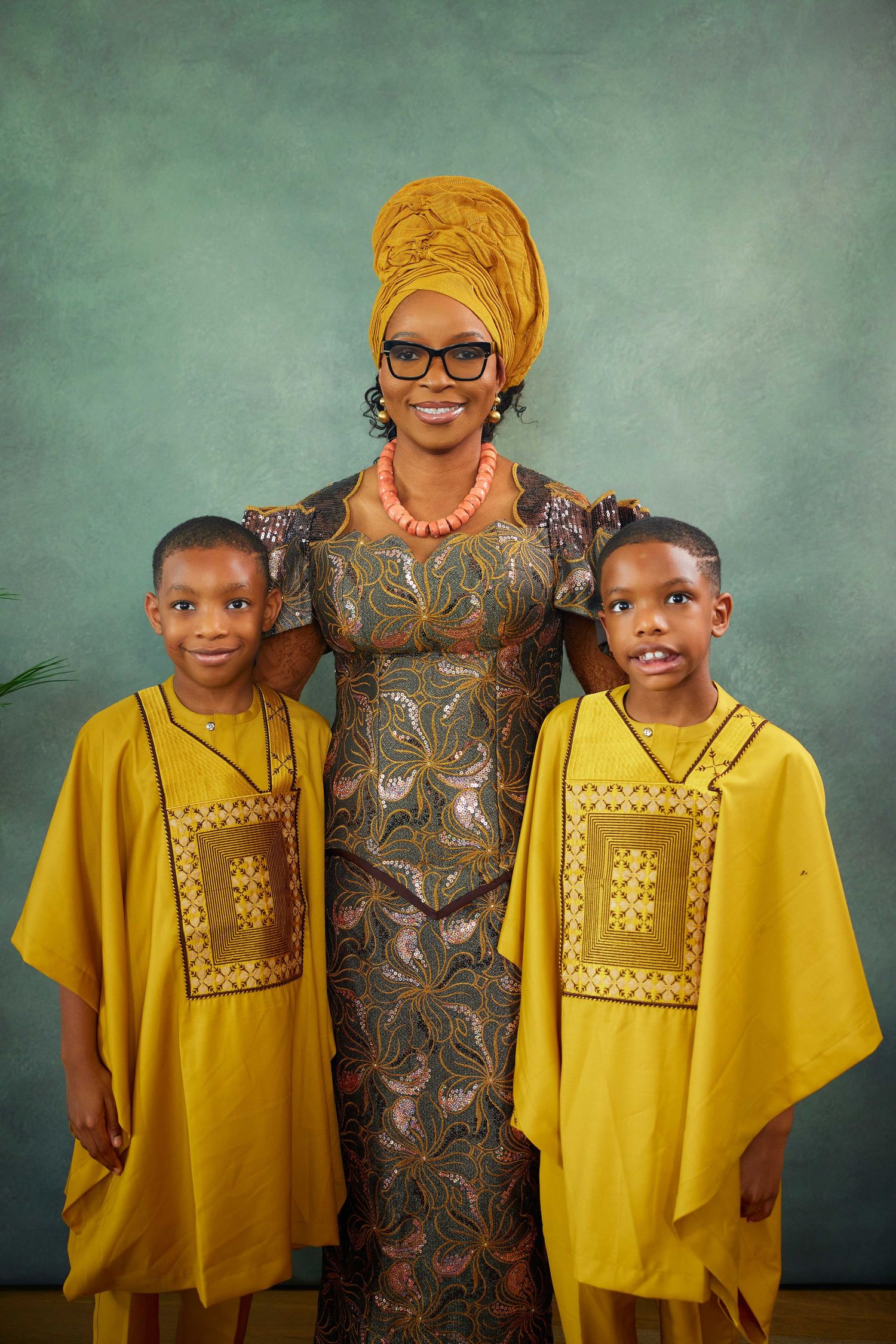A series of portrait photos showing people in vibrant yellow traditional African attire with contrasting brown patterns.