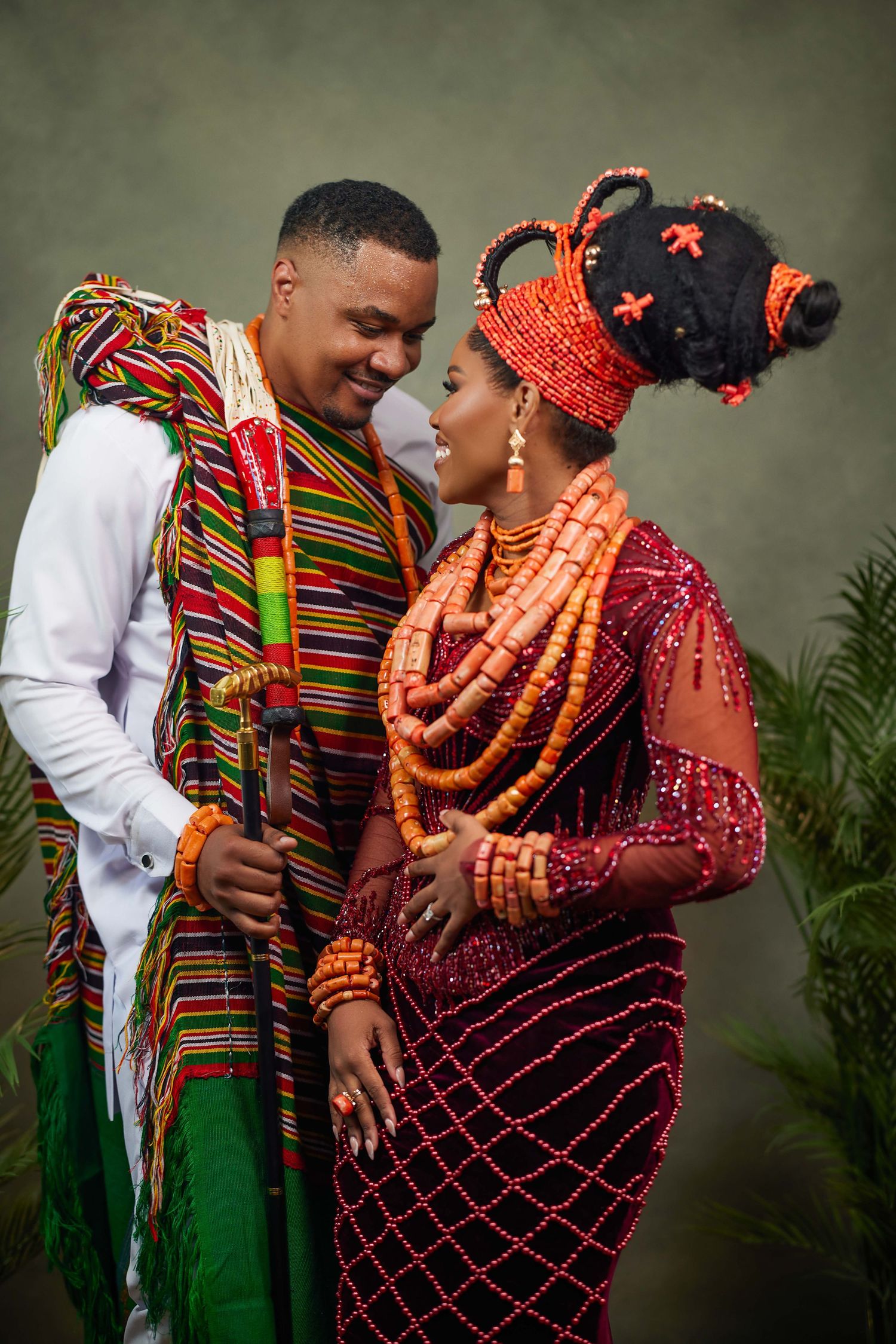 Traditional African wedding couple in colorful attire share intimate moments during their cultural celebration ceremony.