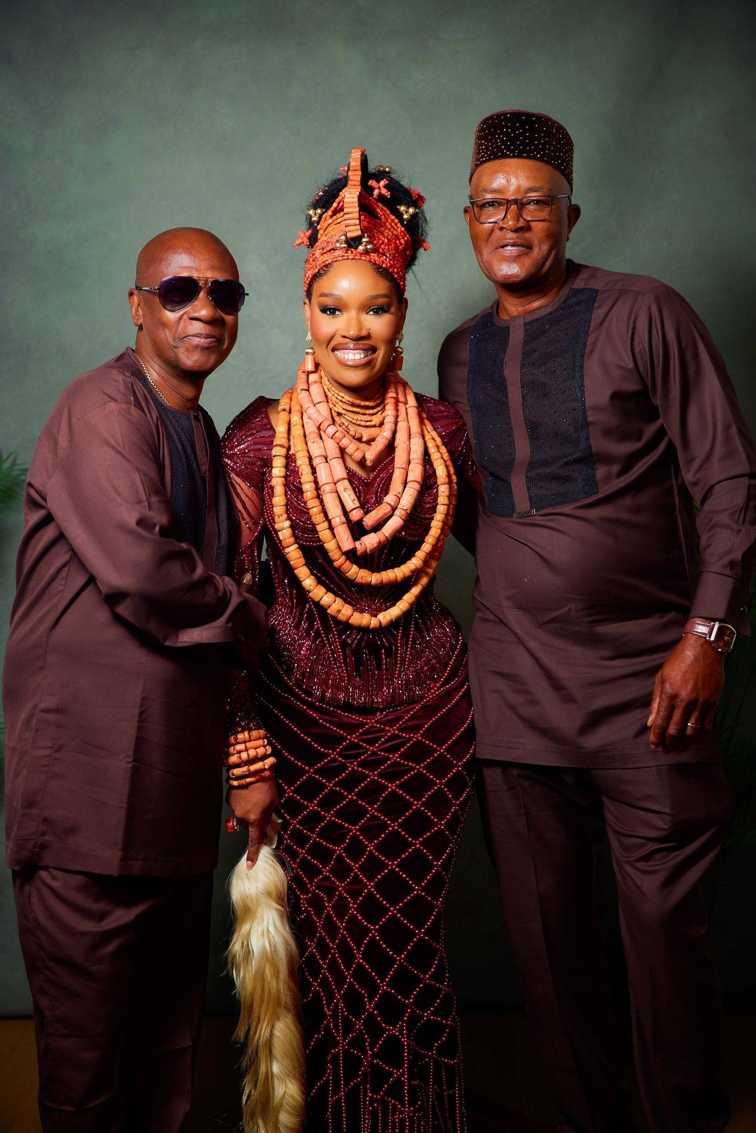 Traditional Nigerian wedding portraits featuring elegant black and coral attire with cultural coral beaded jewelry.