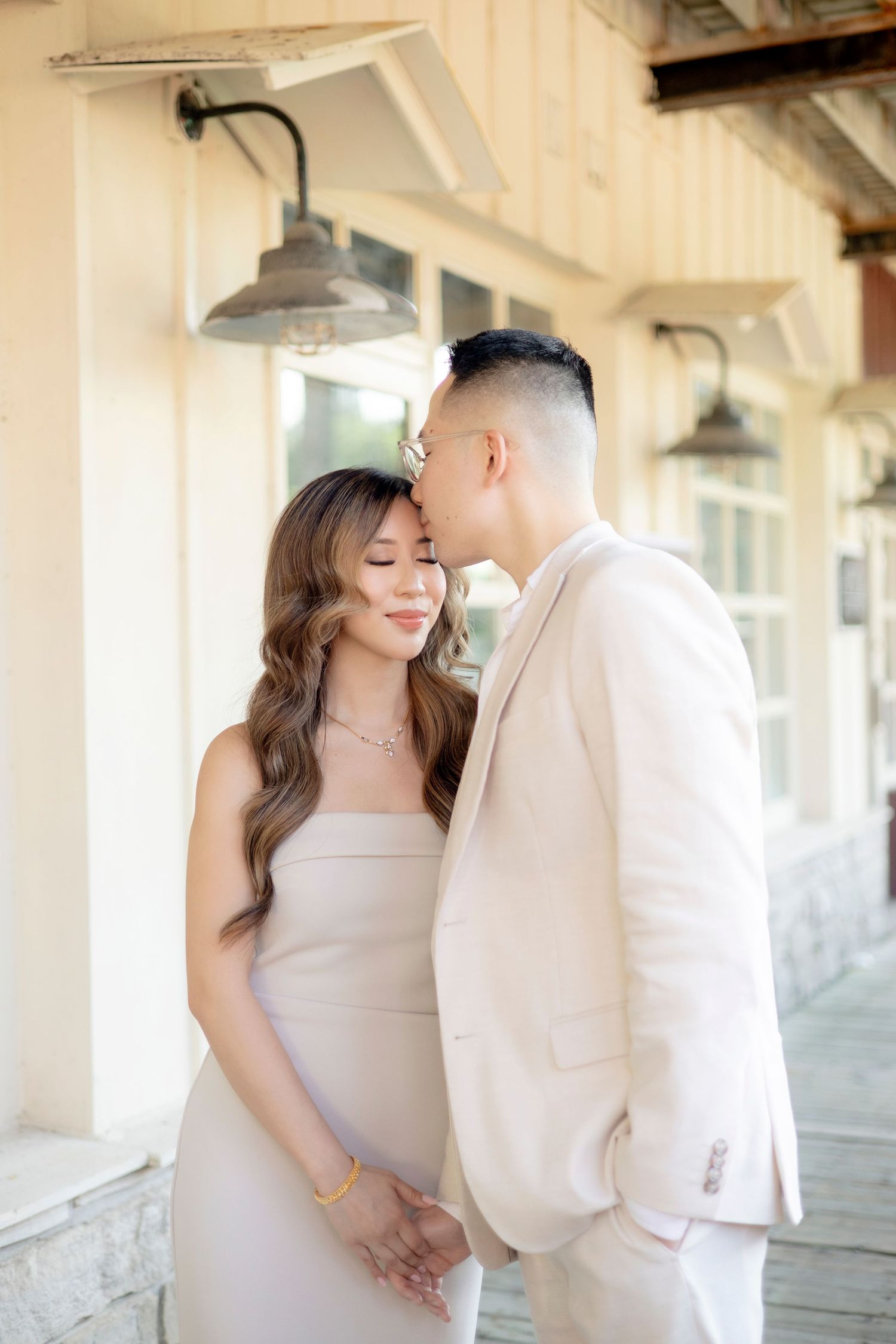An intimate portrait of a couple sharing a tender moment on a vintage covered porch.