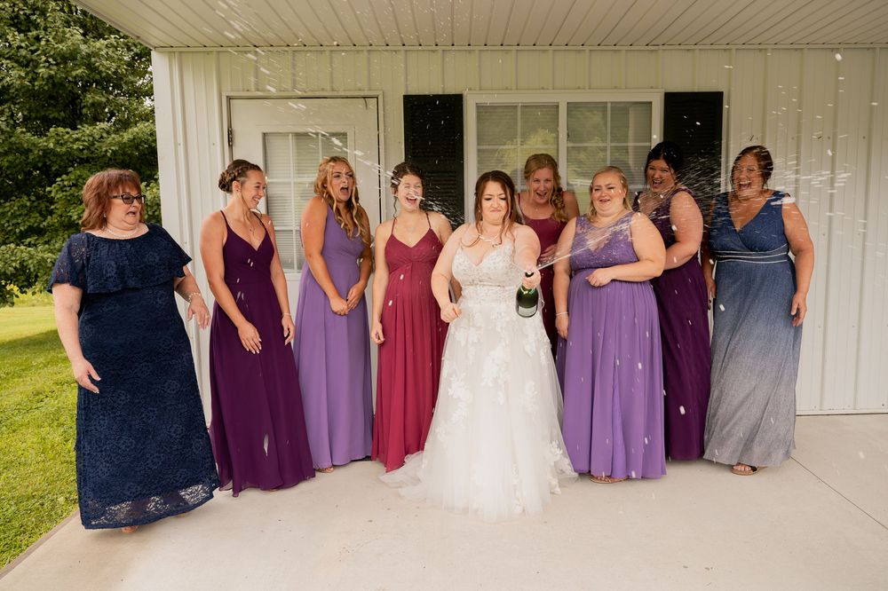 Wedding party in purple and navy dresses poses together on a porch in a panoramic collage.