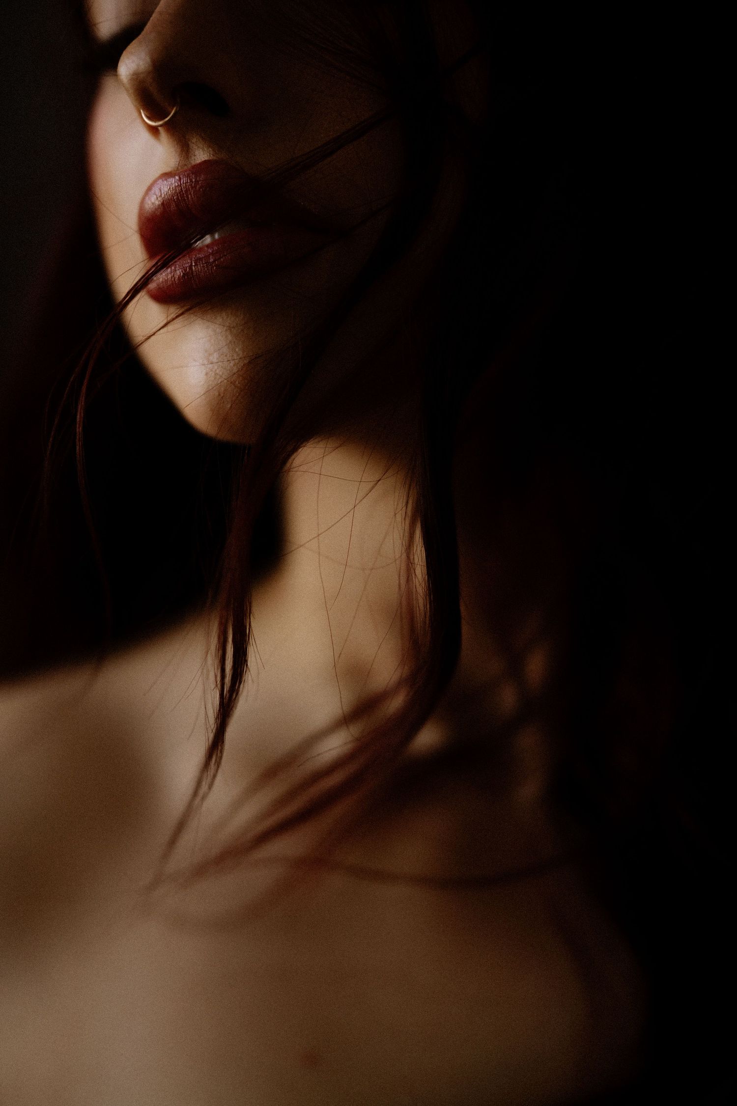 Artistic close-up photography series showing neck and lips in warm moody lighting with dark shadows.