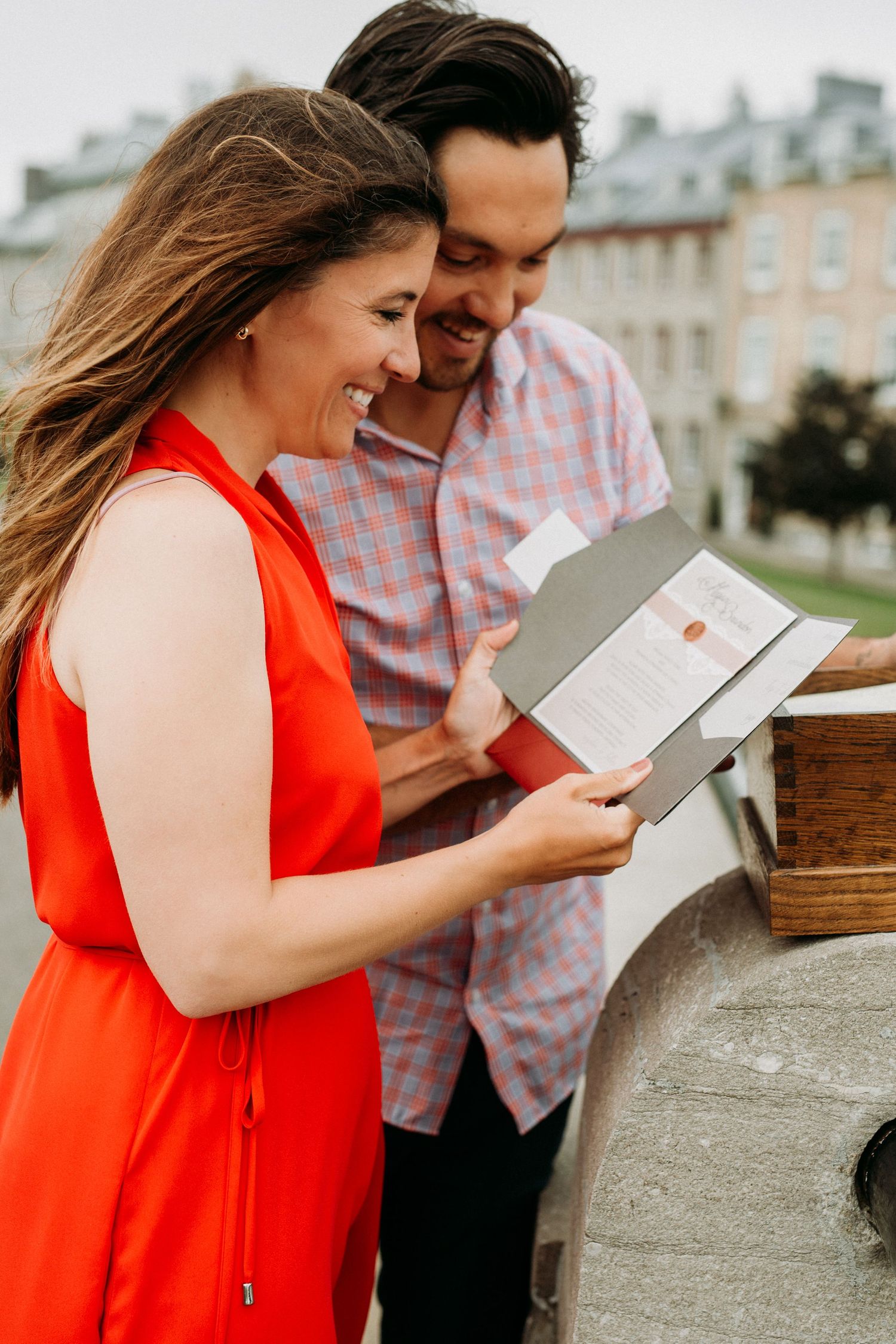 Couple reading together on sunny day in historic Quebec City.