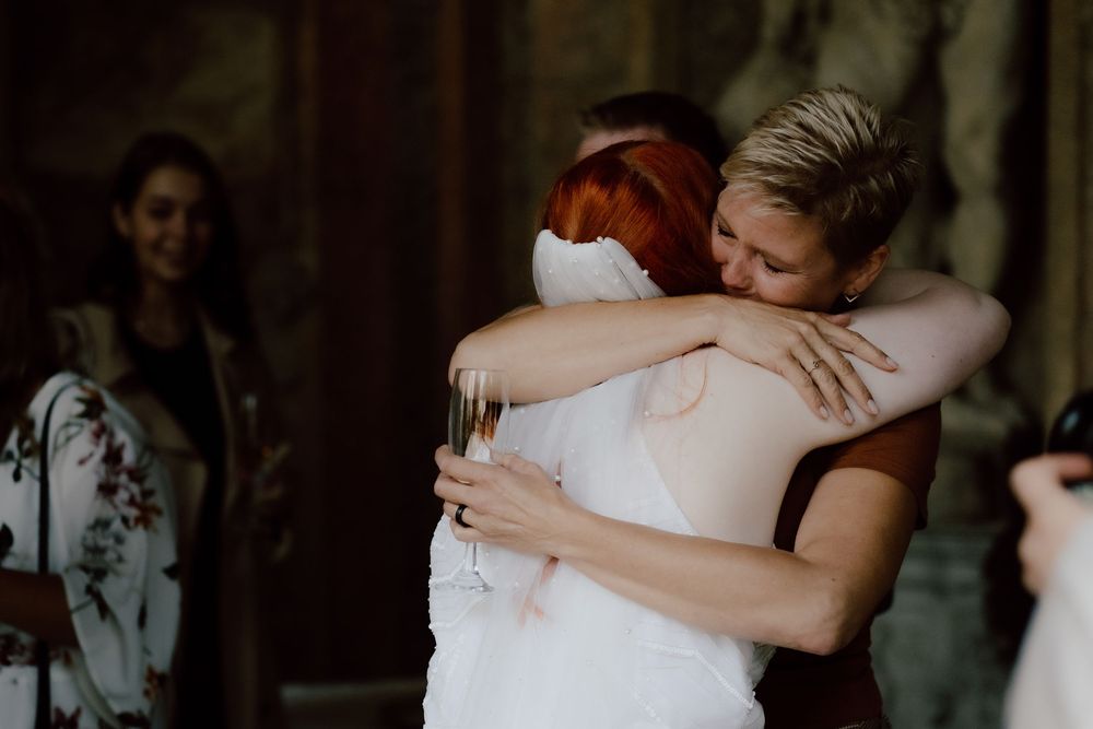 A series of candid wedding photographs showing loving embraces and tender moments between couples.