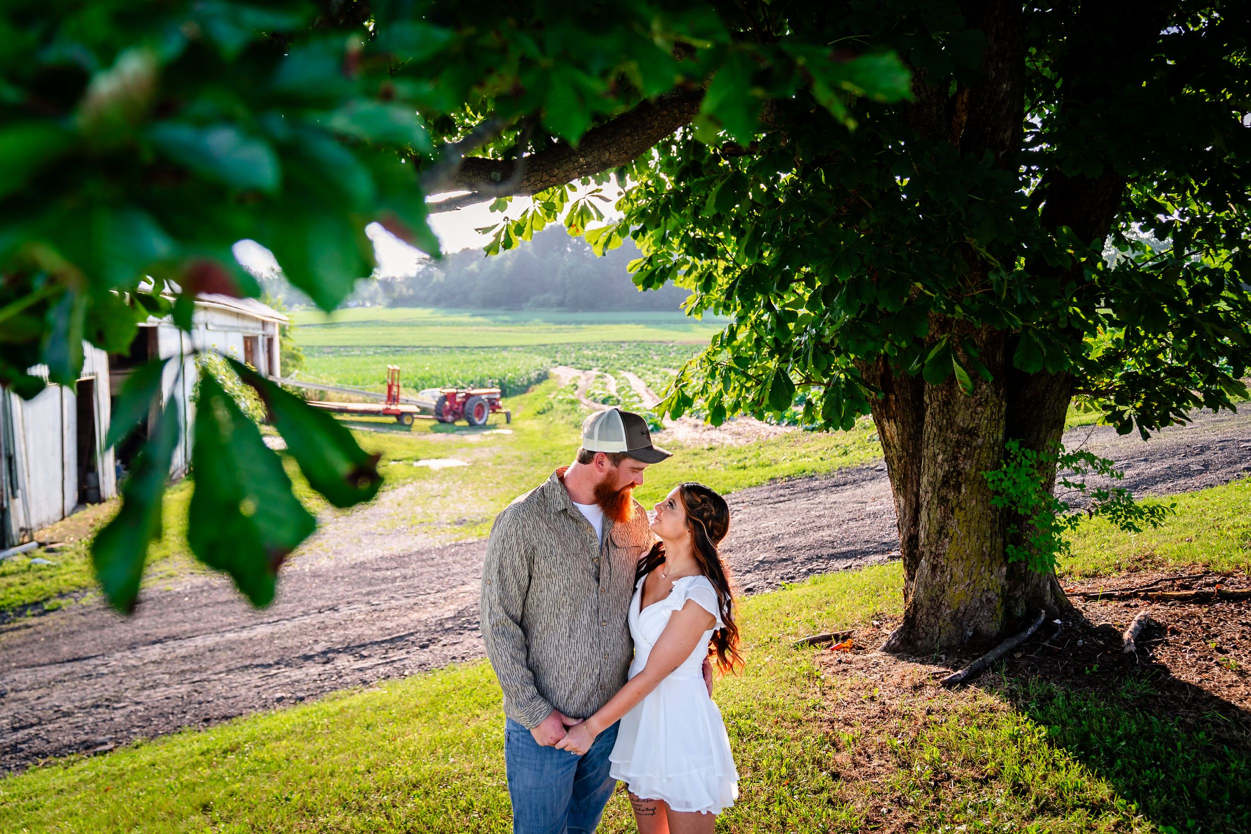 Romantic countryside photoshoot among trees and farmland.