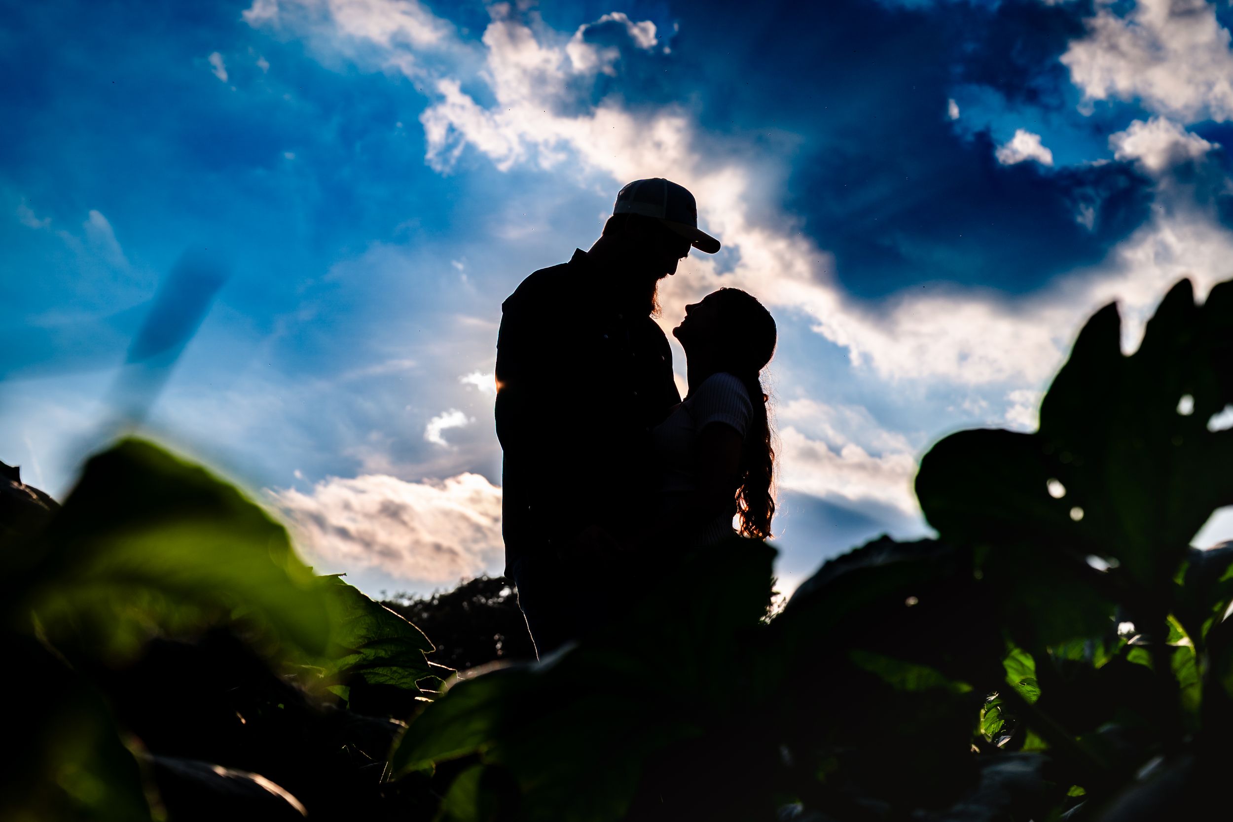 Dramatic silhouettes against sunset sky with dramatic cloud formations.
