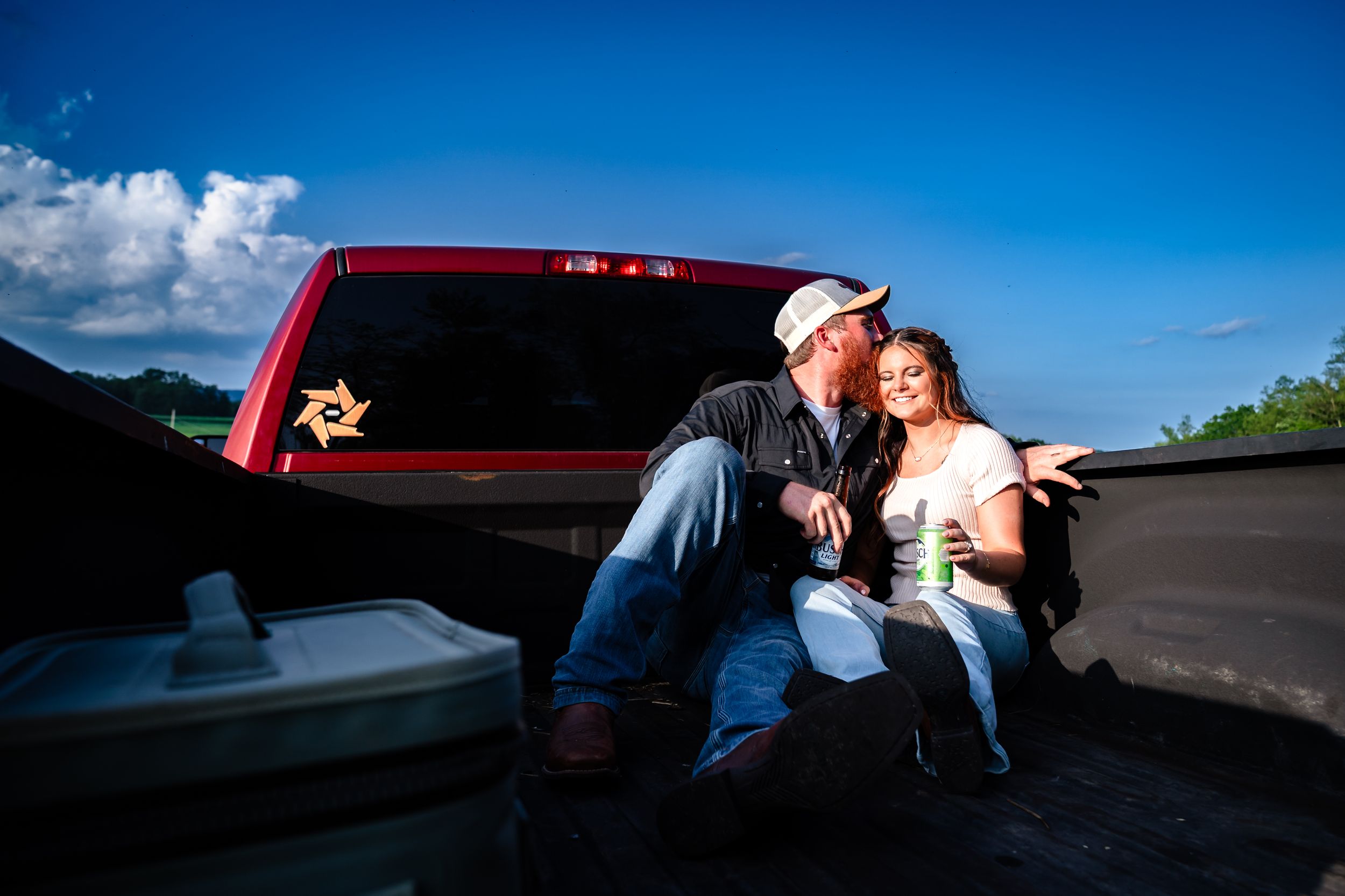 Romantic sunset photoshoot featuring a couple posing together near a vintage car.