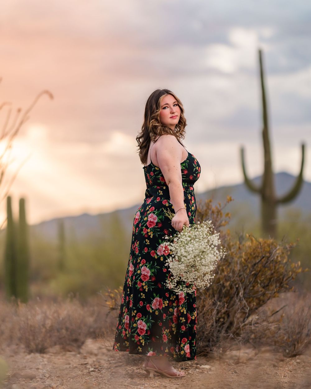 Unique senior pictures with flowers in the desert and stormy skies- Tucson Senior Photographer