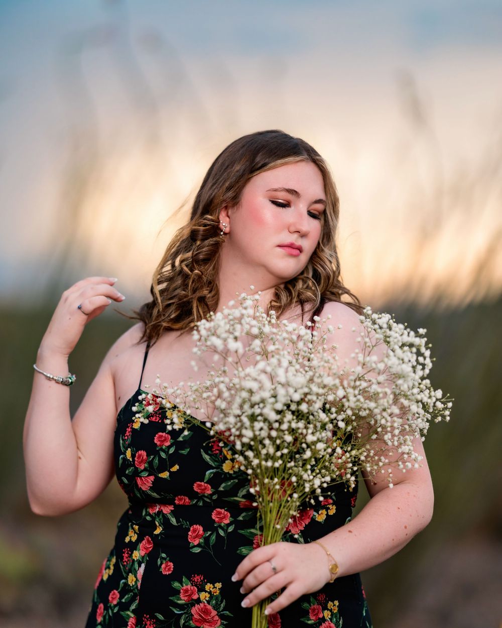Unique senior pictures with flowers in the desert and stormy skies- Tucson Senior Photographer