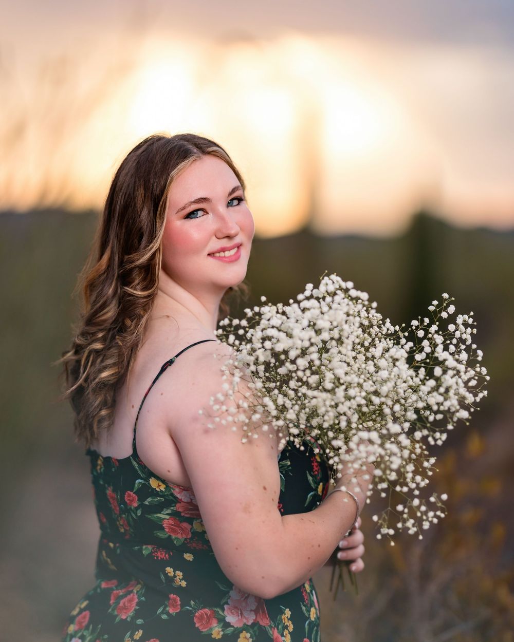 Unique senior pictures with flowers in the desert and stormy skies- Tucson Senior Photographer