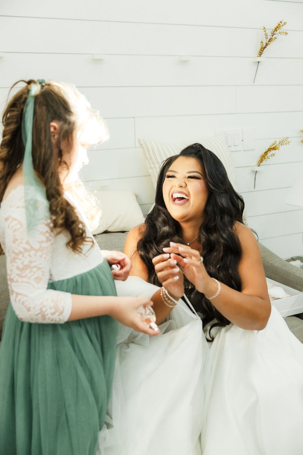 Joyful moment shared between friends during wedding preparations.