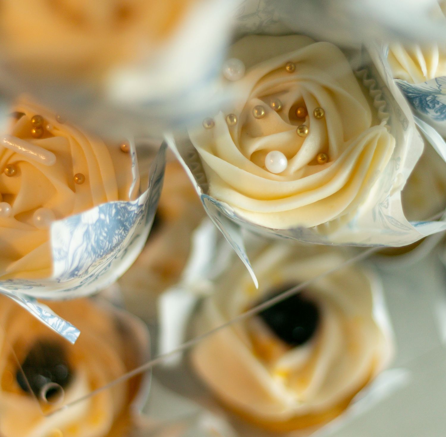 Extreme close-up macro photography of delicate white rose petals with soft bokeh lighting effects creating a dreamy atmosphere.