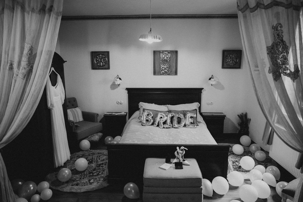 A monochrome view of a bridal suite with balloons and decorative elements.