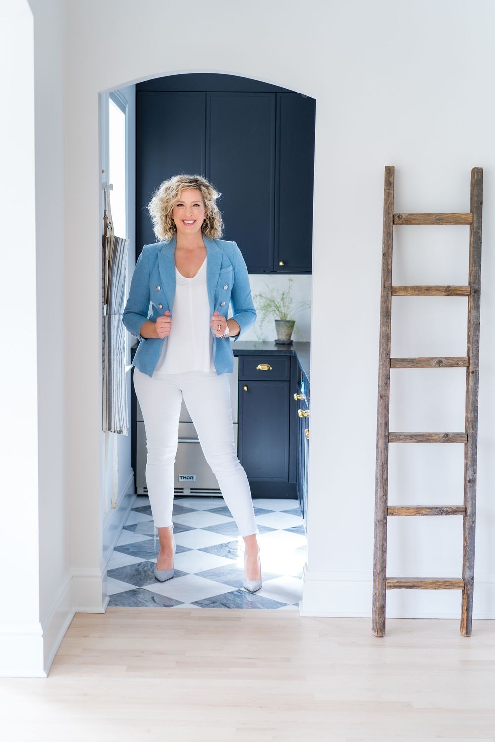 Light blue blazer outfit photographed in modern kitchen with wooden ladder decor.