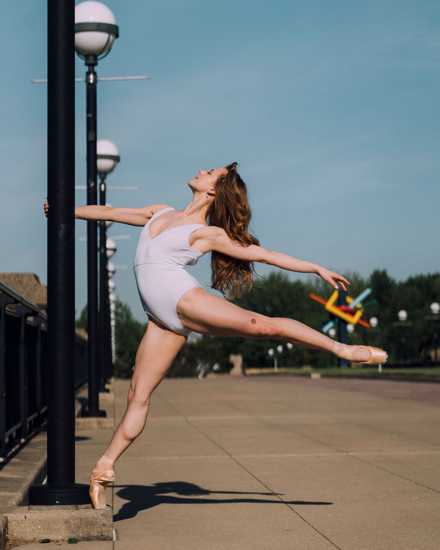 Indianapolis dance photographer photographing Indy Ballet Dancer during an early morning ballet session with golden sunlight